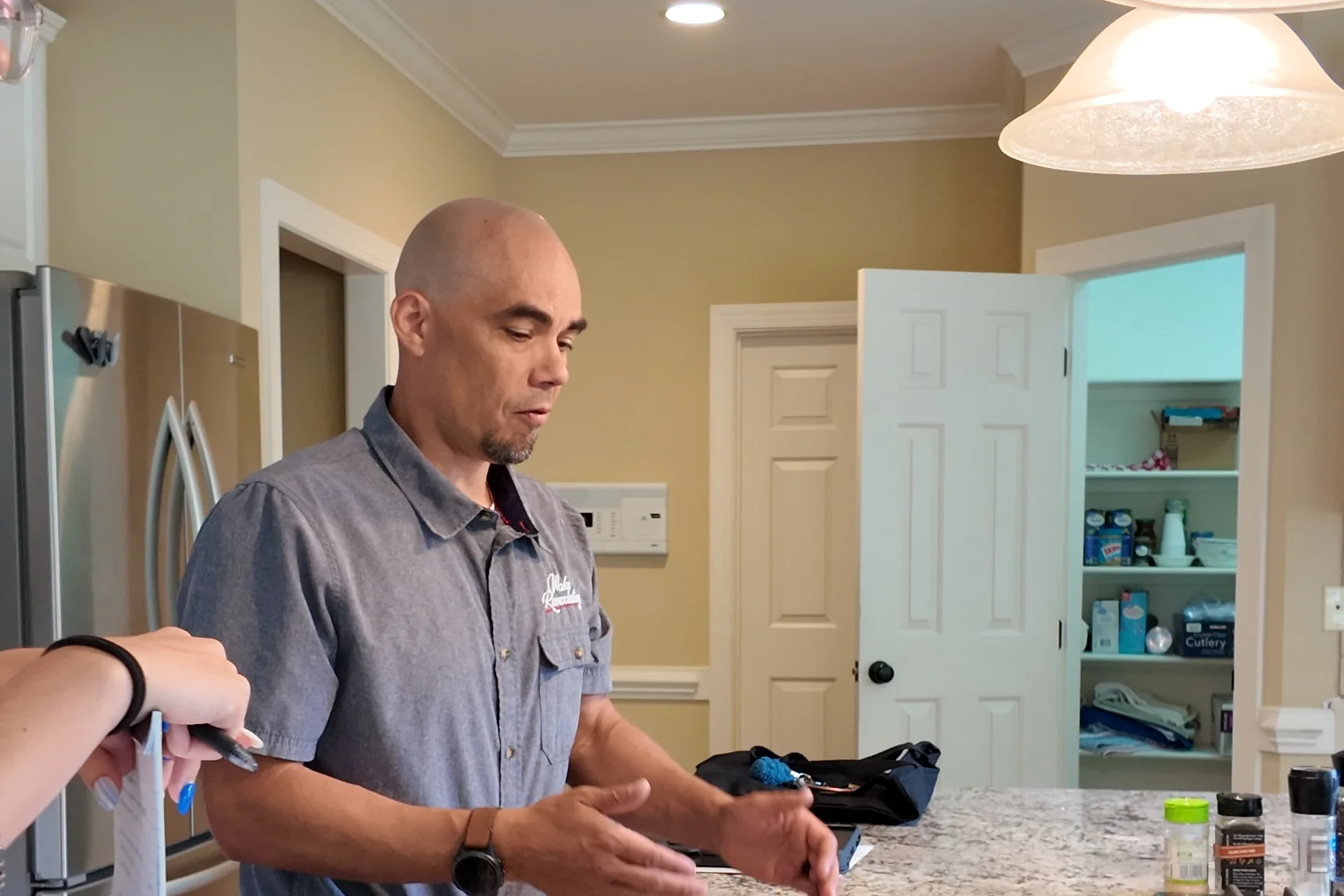 Luke from Wake Remodeling reviewing project details with a homeowner in their kitchen during a 60 minute consultation