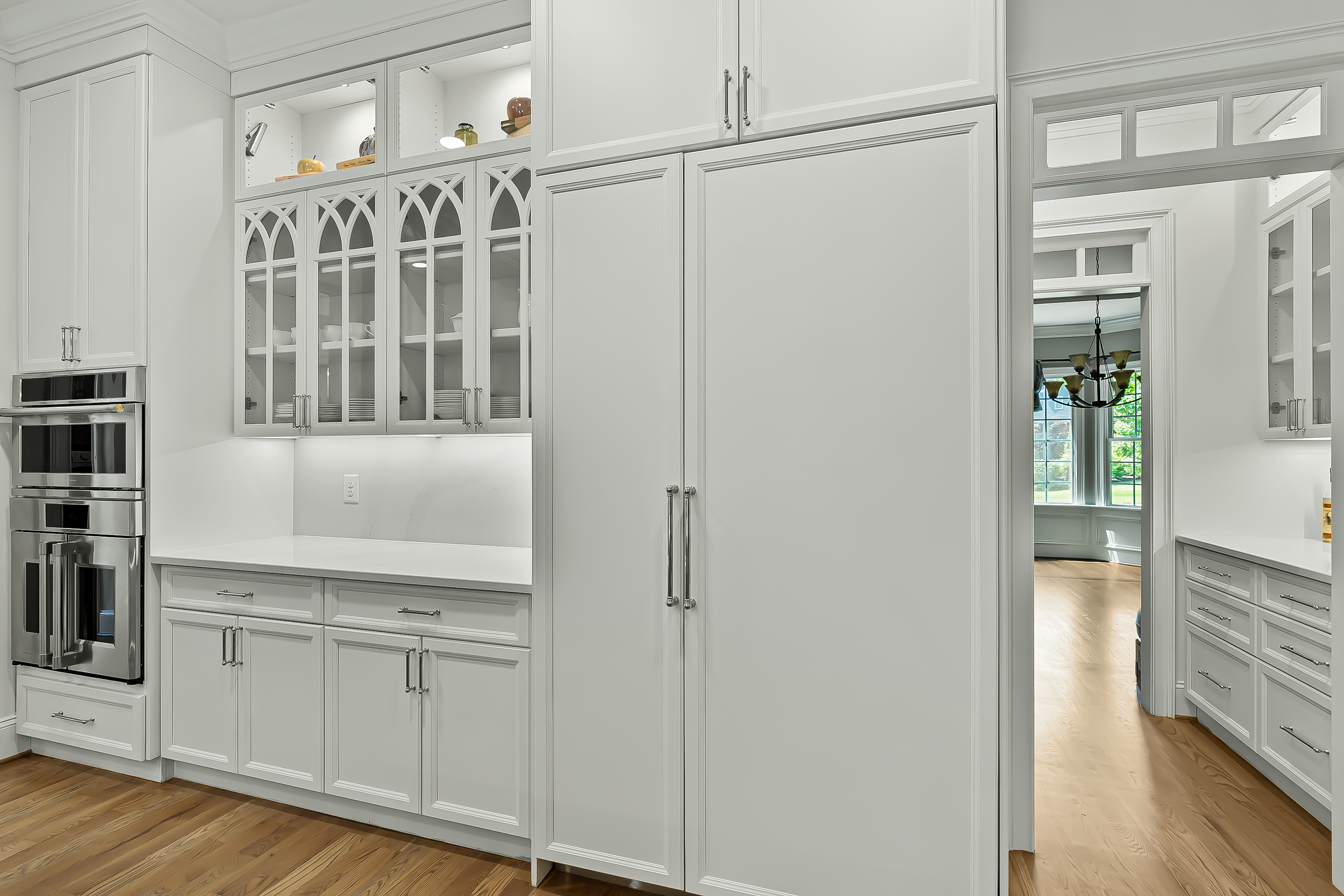 Kitchen appliances pictured: panel-ready refrigerator and freezer, convection oven, and 5-in-1 oven.