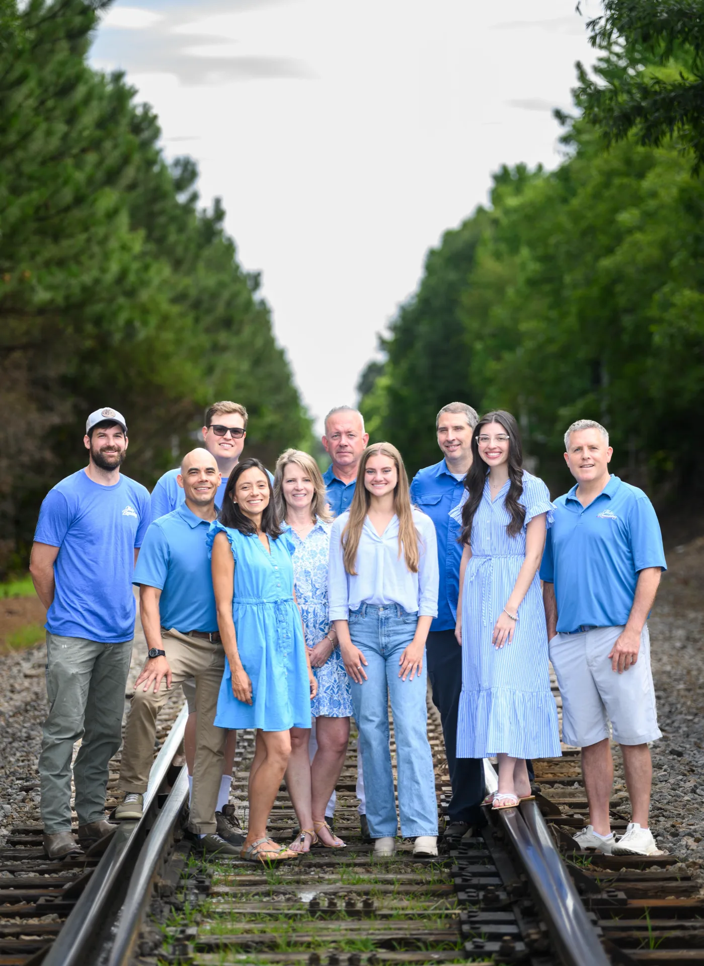 The Wake Remodeling team standing together on railroad tracks in Apex, NC