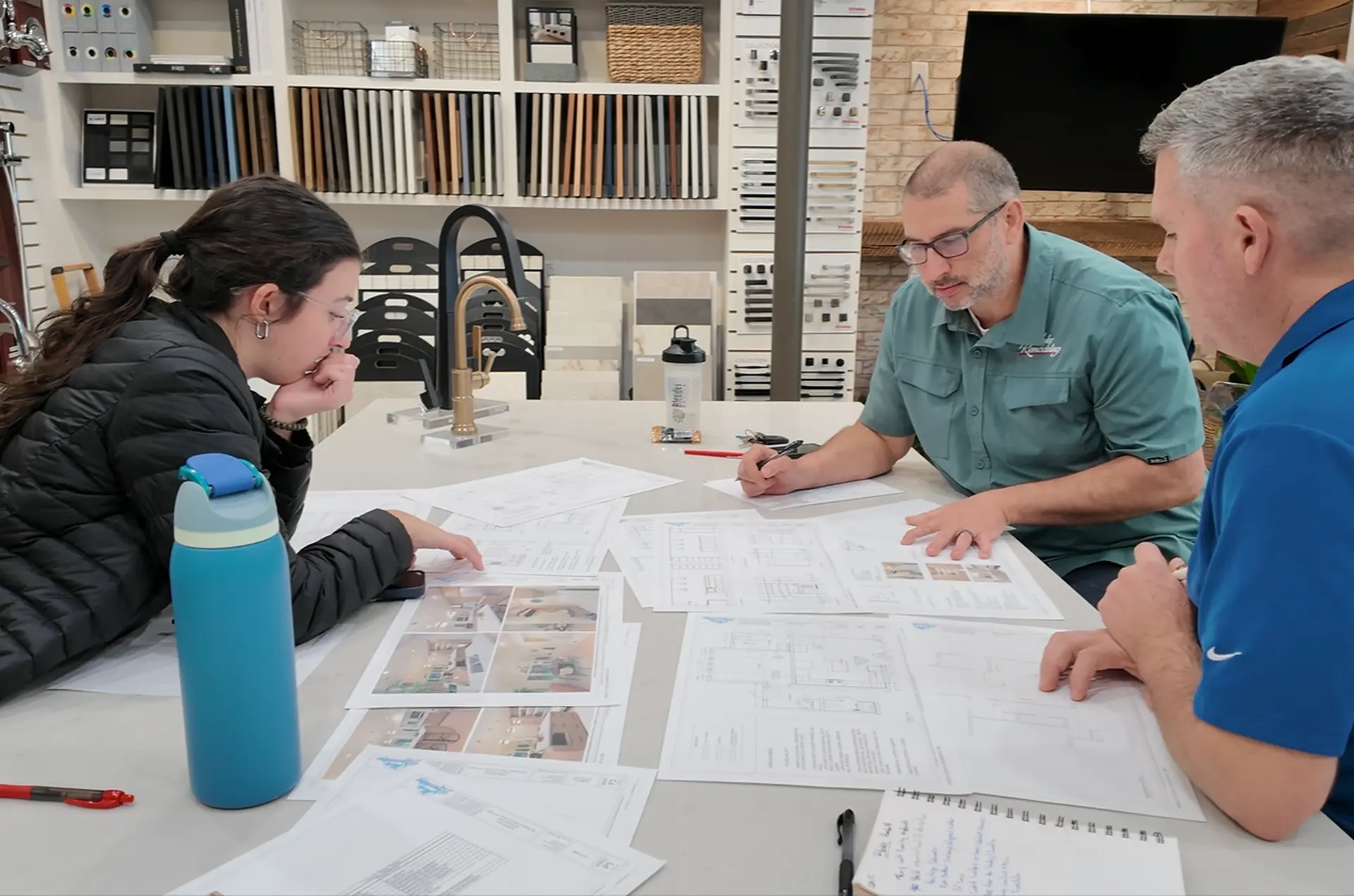 Wake Remodeling team reviewing project documents and proposals in the showroom